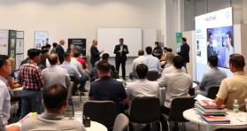 Training room with exhibitors engaging in a group discussion.